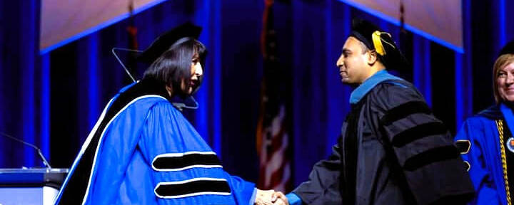 President Mantella shakes a new OT graduate's hand